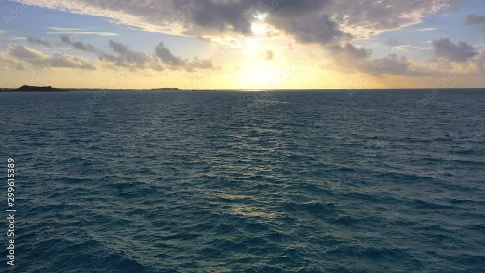 Aerial: Dark Blue Choppy Water and Sunset on the Horizon - Providenciales, Turks and Caicos Aerial: Dark Blue Choppy Water and Sunset on the Horizon - Providenciales, Turks and Caicos