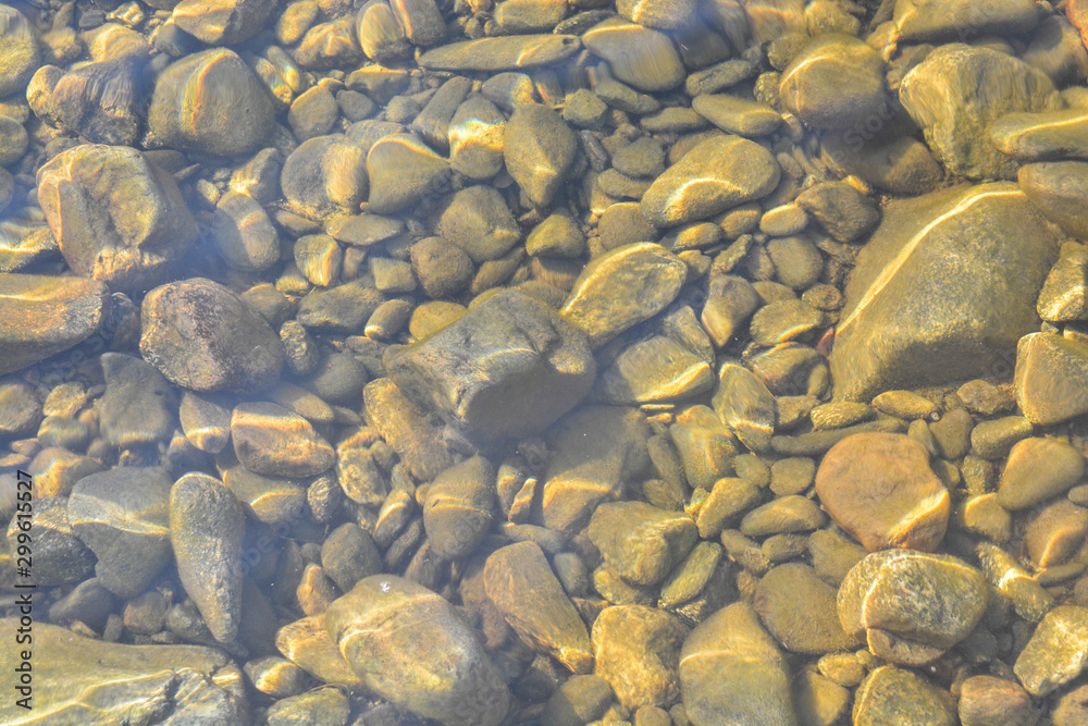 Background of shiny pebbles on the river bottom. Background of shiny pebbles on the river bottom.