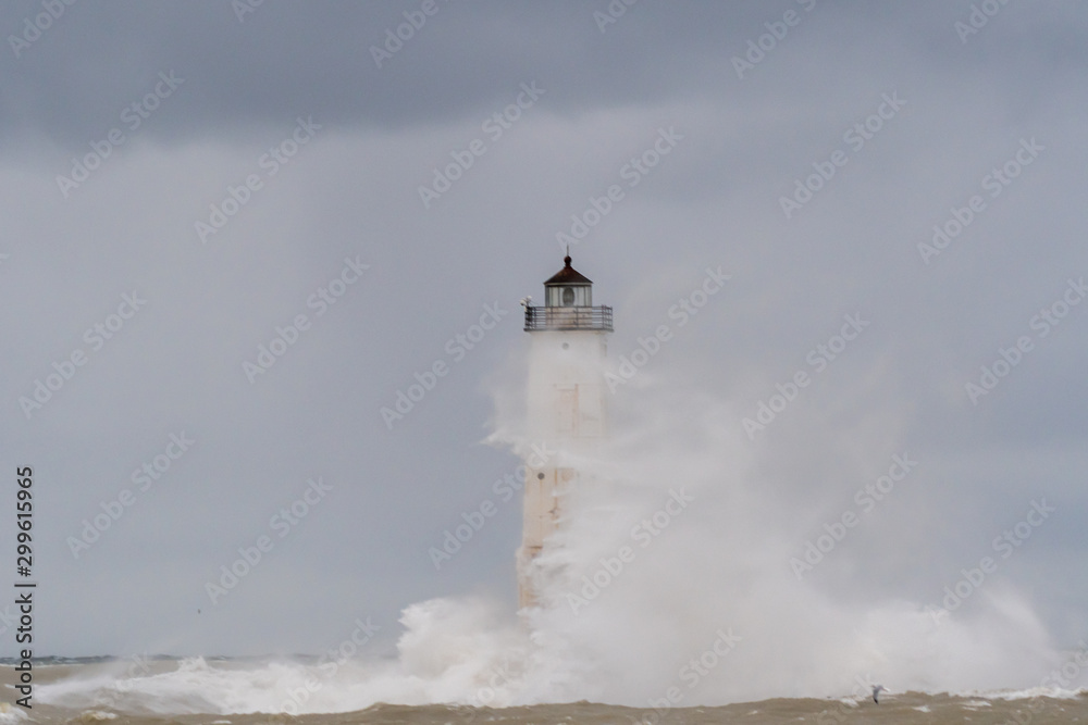 Breaking waves swirl aound the Frankfort North Breakwater Lighthouse