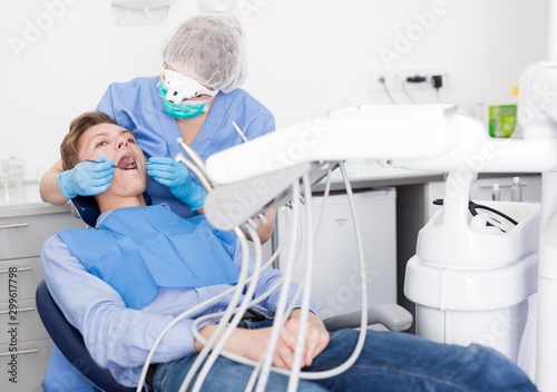 Young man on dental checkup in modern dentist office