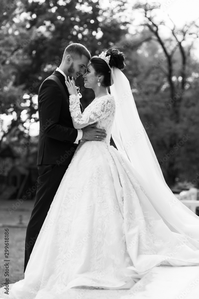 Pretty bride and stylish groom with beard. Loving wedding couple outdoor. Sensual romantic moment. Wedding  in autumn. 
