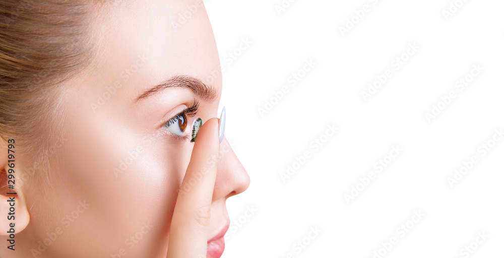 Side view on young woman wearing green contact lenses. Side view on young woman wearing green contact lenses.