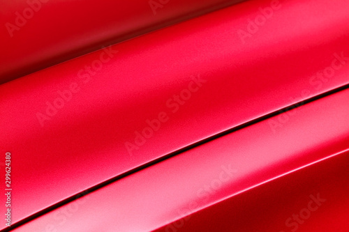 Red car bodywork, detail of hood and fender of sport sedan, automobile industry, selective focus, abstract