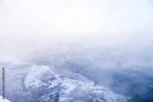 Winter landscape of frosty trees, white snow in city park. Trees covered with snow in Siberia, Irkutsk near lake Baikal. Extremely cold winter