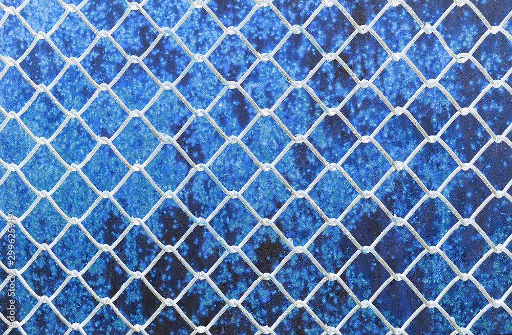 metal grid on cracked wood background metal grid on cracked wood background