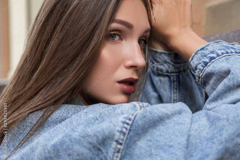 Young caucasian stylish woman in casual outfit on a european city street. She alone outdoors. Young caucasian stylish woman in casual outfit on a european city street. She alone outdoors.