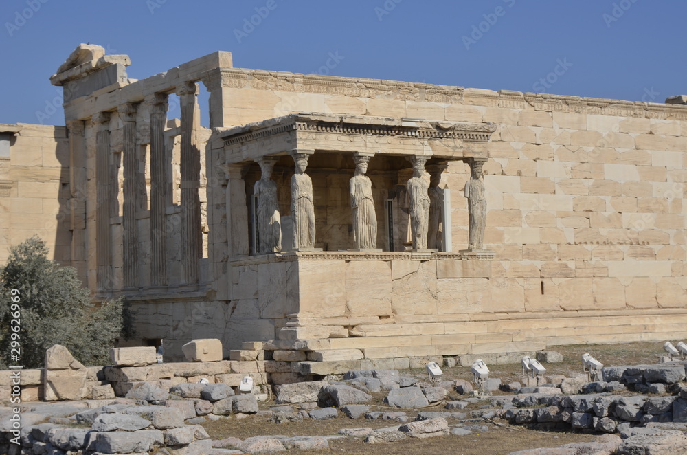 Athens, Greece, 10.28.2019. Ruins of Erechtheion (or Erechtheum) temple on a bright day in  Athenian Acropolis - world heritage site. Ancient Greek temple. Columns and statues of women.