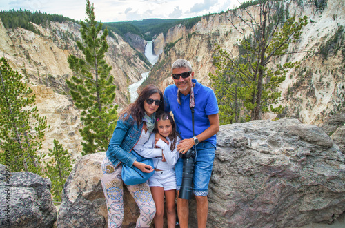 Happy family enjoying visit to the canyon. Father with big camera