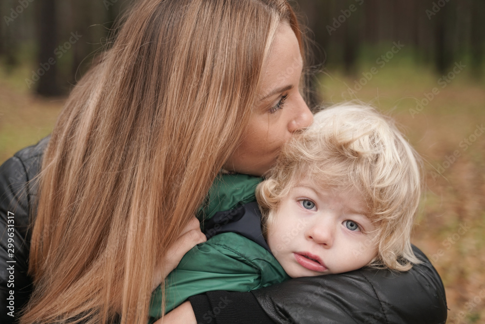caucasian young mother and little child having fun in autumn Park, walking caucasian young mother and little child having fun in autumn Park, walking