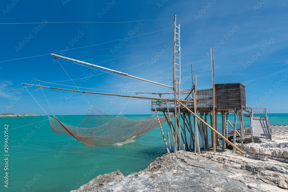 Typical traditional fishing trabucco at the beach of Vieste along the Adriatic Sea in Puglia, Italy.