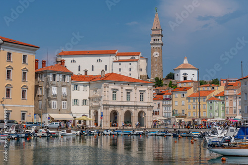 Venetian Port and the Main Square Tartini of Piran city reflected on water, Slovenia.