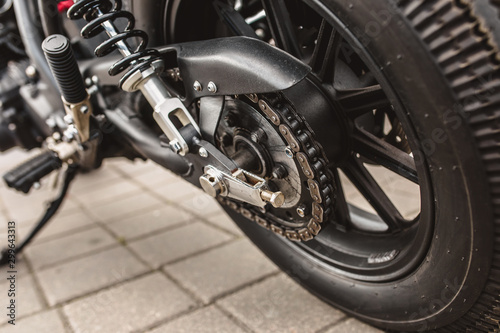 Close up detail of a powerful vintage motorcycle - rear suspension and drive wheel