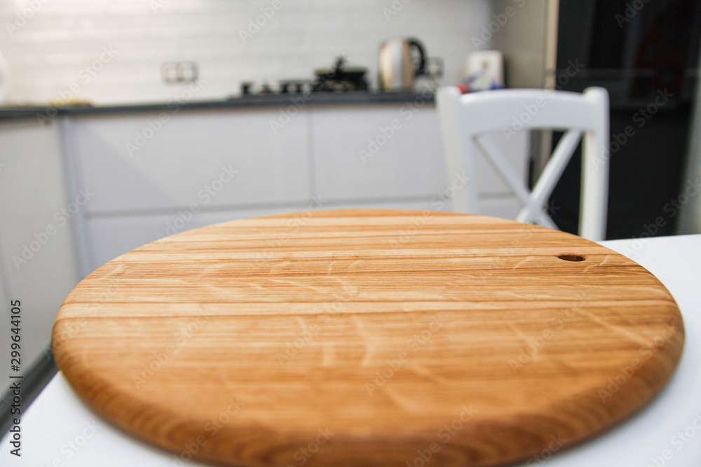 wooden board and blurred kitchen background. place for your item.