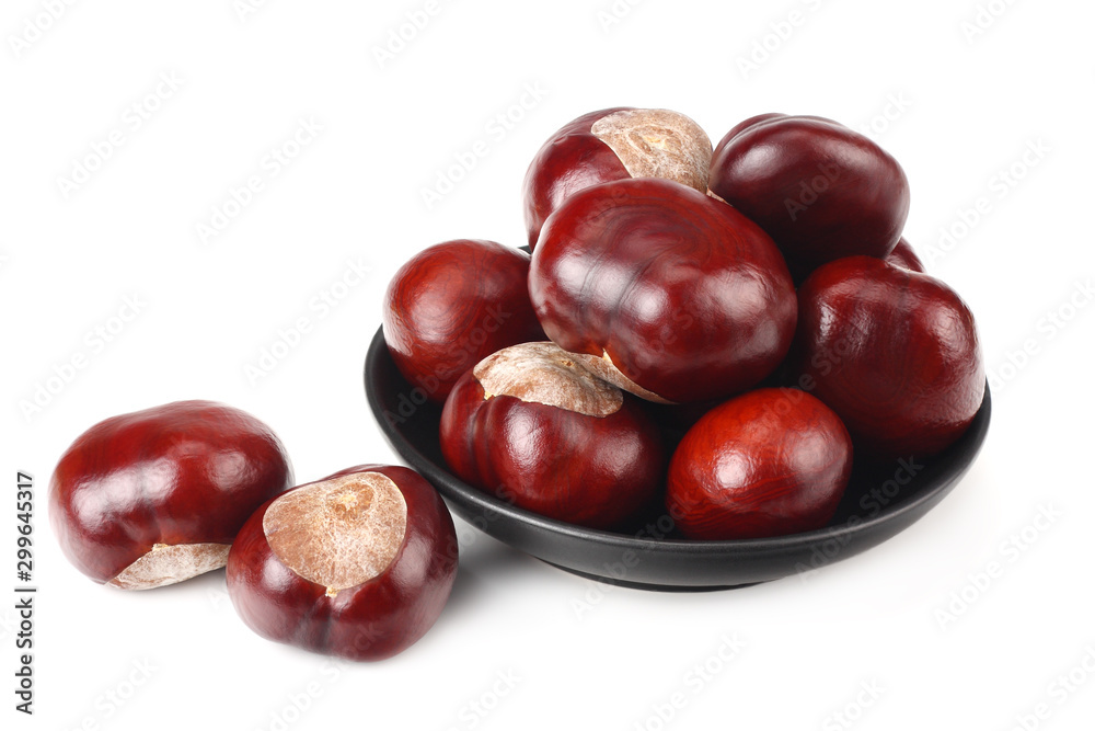 chestnuts in a black plate isolated on white background chestnuts in a black plate isolated on white background