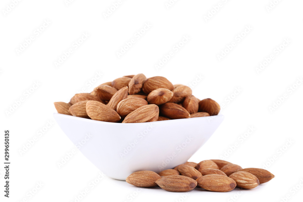 Almonds in bowl isolated on white background Almonds in bowl isolated on white background