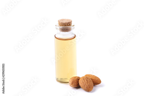 Almond and oil in bottle on white background