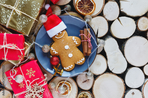 Homemade gingerbreads on plate on wooden background. Holidays and celebration concept, greeting card mockup, festive decoration. Christmas and New Year composition.