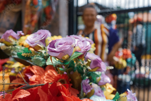 Old woman selling natural and artificial flowers for the Day of the Dead (Dia de los muertos) in Managua, Nicaragua, Central America