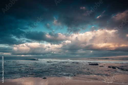 Jeffrey's bay beach, beautiful dramtaic sunset, empty beach with moody filter applied to the image, lot of space in the sky to add text