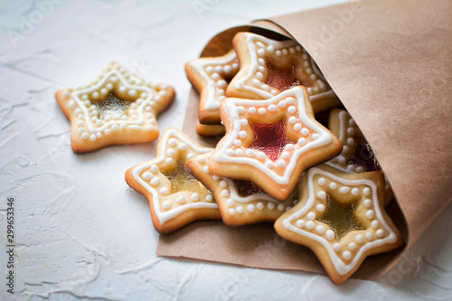 Homemade Christmas star shape sugar caramel cookies in a paper package on white background 