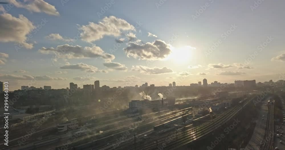 Modern city with railroad and cars passing by against the sky. 4K video, 240fps, 2160p. Modern city with railroad and cars passing by against the sky. 4K video, 240fps, 2160p.