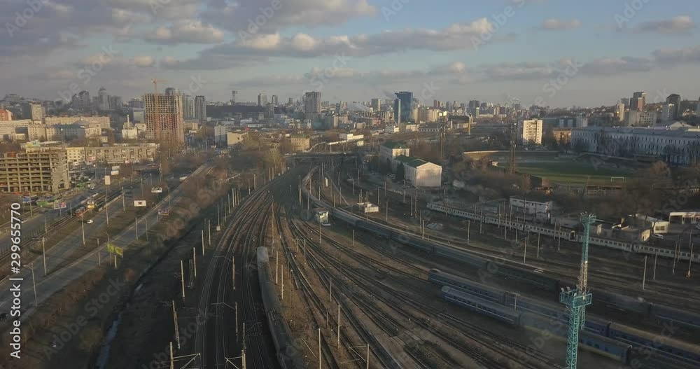 Railway station and passing trains on the background of the city on a sunny day. 4K video, 240fps, 2160p. Railway station and passing trains on the background of the city on a sunny day. 4K video, 240fps, 2160p.