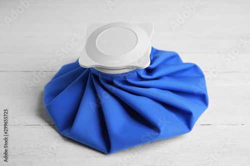 Картината върху платно Ice pack on white wooden table. Cold compress
