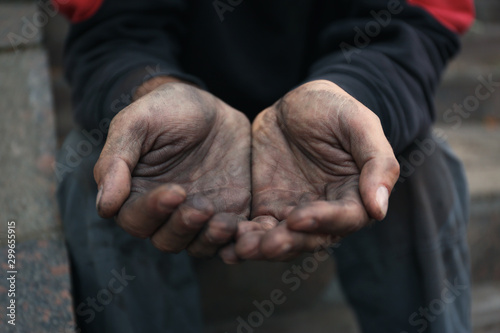 Poor homeless man begging for help outdoors, closeup