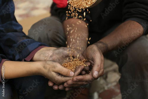 Poor homeless people taking wheat from donator outdoors  closeup