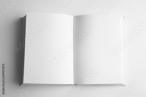 Open book with blank pages on white background, top view. Mock up for design