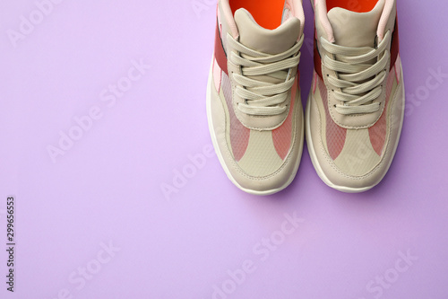 Pair of stylish shoes on lilac background, top view. Space for text
