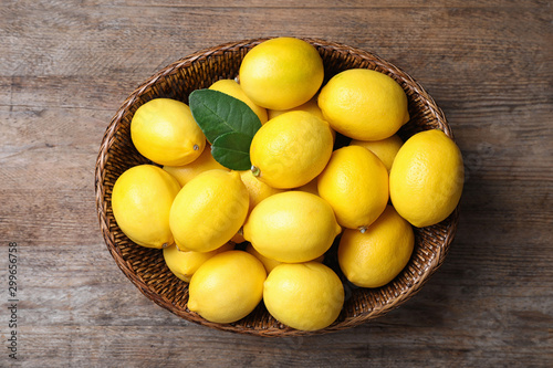 Fresh ripe lemons on wooden table, top view