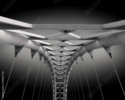 Fototapeta Naklejka Na Ścianę i Meble -  Gray scale closeup shot of a metal bridge with wires connected to it