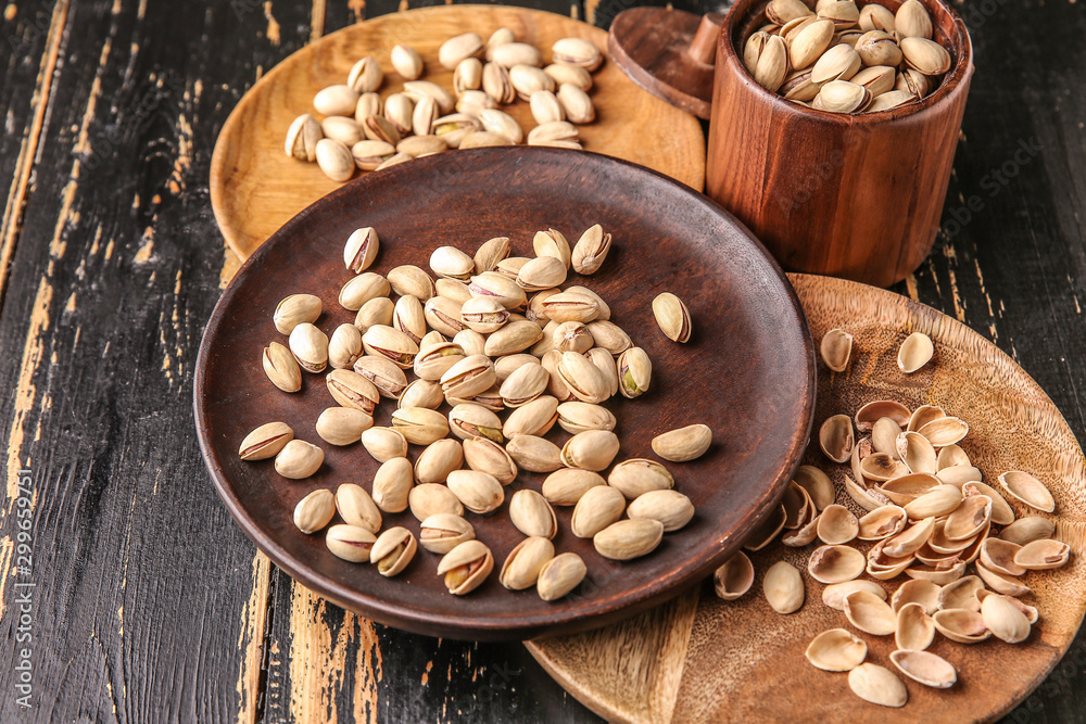 Tasty pistachio nuts on dark table Tasty pistachio nuts on dark table