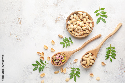 Tasty pistachio nuts on white background