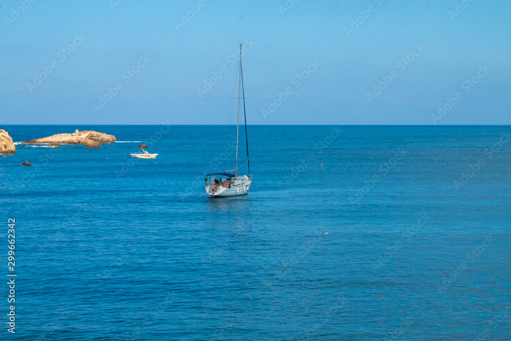 Fototapeta premium Sailing yacht in the blue sea. Ship yacht sails in the open Sea. Luxury boats. Crete, Greece. Aegean sea. Copy Space.