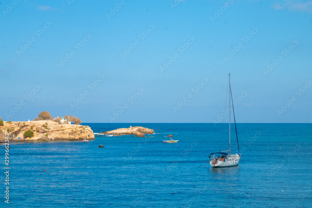 Sailing yacht in the blue sea. Ship yacht sails in the open Sea. Luxury boats. Crete, Greece. Aegean sea. Copy Space.