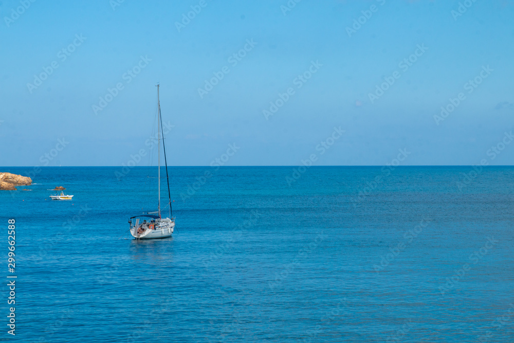 Sailing yacht in the blue sea. Ship yacht sails in the open Sea. Luxury boats. Crete, Greece. Aegean sea. Copy Space. Sailing yacht in the blue sea. Ship yacht sails in the open Sea. Luxury boats. Crete, Greece. Aegean sea. Copy Space.