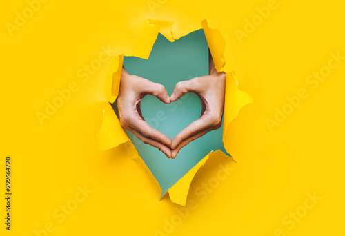 Female hands show a heart s...