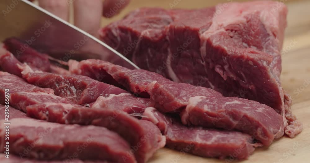 Close up of cutting beef with chef knife, marinate meat, macro shot of cooking process, dramatic look, preparing a dinner, slow motion, red epic Close up of cutting beef with chef knife, marinate meat, macro shot of cooking process, dramatic look, preparing a dinner, slow motion, red epic