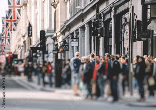 Pedestrians waiting to cross the Regent Street in London on a warm spring day
