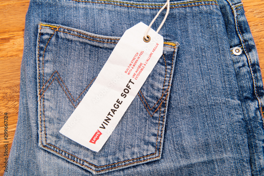 PARIS, FRANCE - JAN 2, 2018: New Jeans with price tag manufactured by the  Levi's placed on natural wooden table - model Vintage Soft Stock Photo |  Adobe Stock