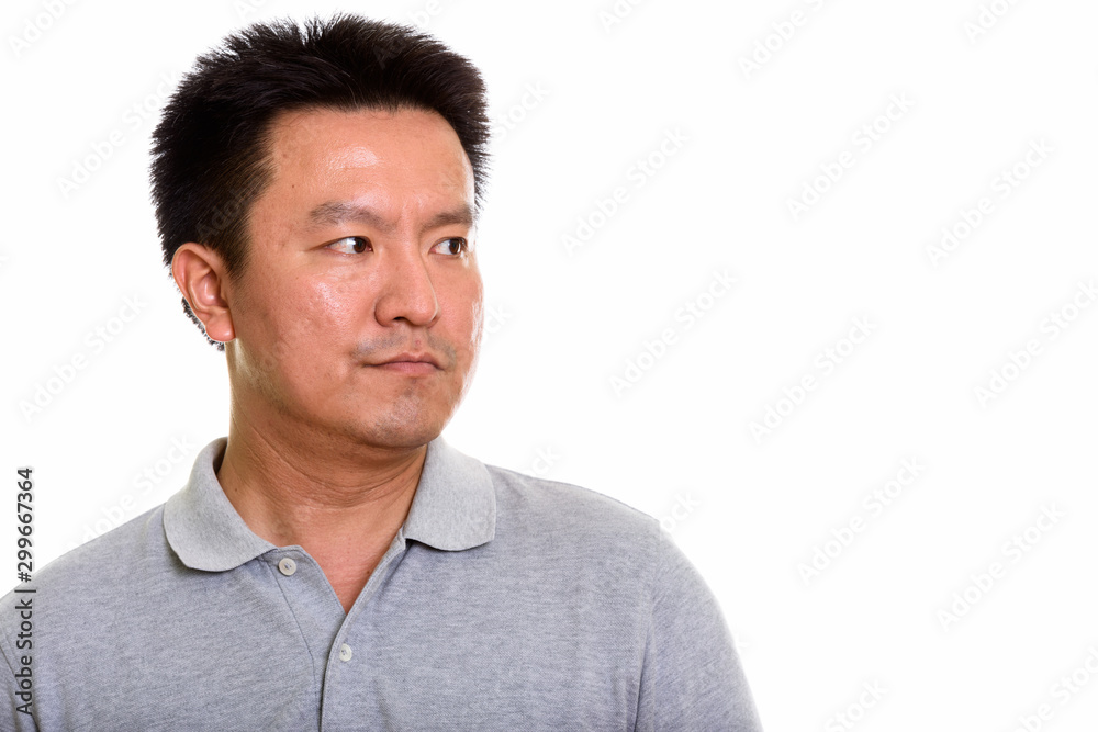 Studio shot of Japanese man isolated against white background Studio shot of Japanese man isolated against white background
