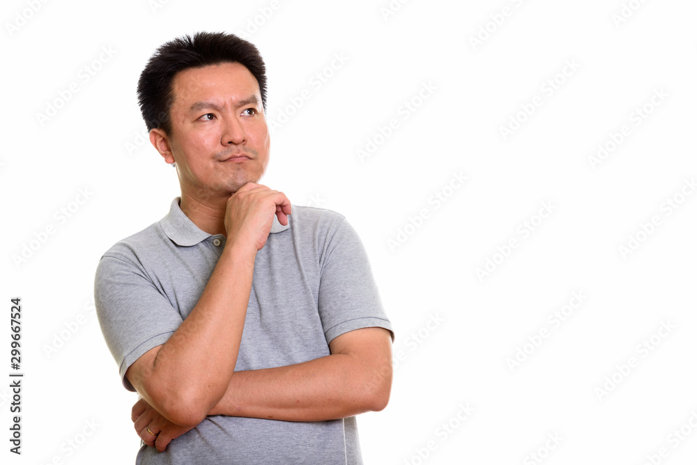 Studio shot of Japanese man isolated against white background Studio shot of Japanese man isolated against white background