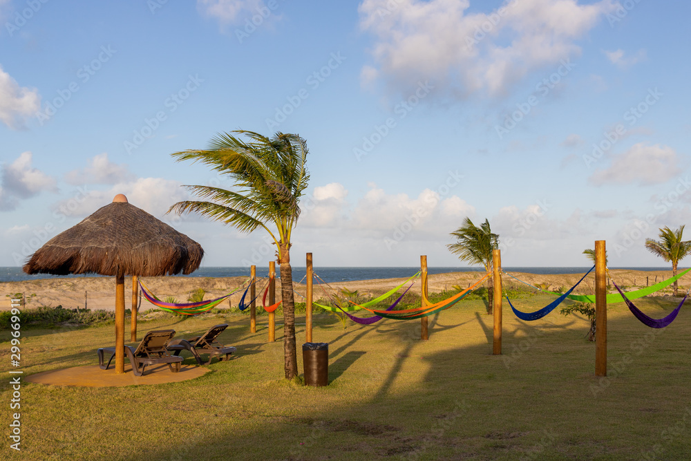 Straw kiosks on a beach in Brazil on a bright sunny day with blue skies