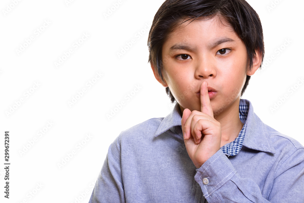 Studio shot of Japanese boy isolated against white background Studio shot of Japanese boy isolated against white background