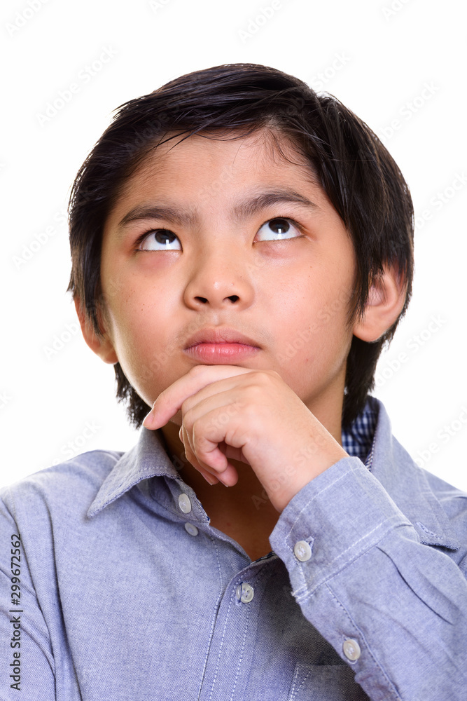 Studio shot of Japanese boy isolated against white background Studio shot of Japanese boy isolated against white background