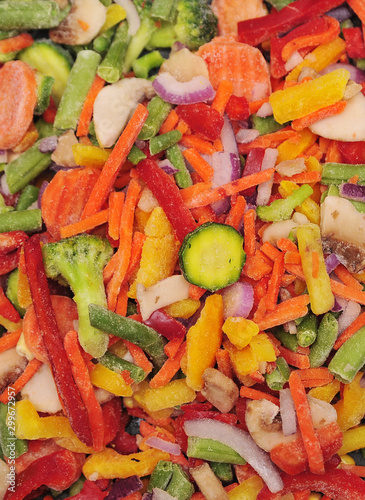 Healthy food texture. Frozen vegetables. Carrots, broccoli, tomatoes, onions.