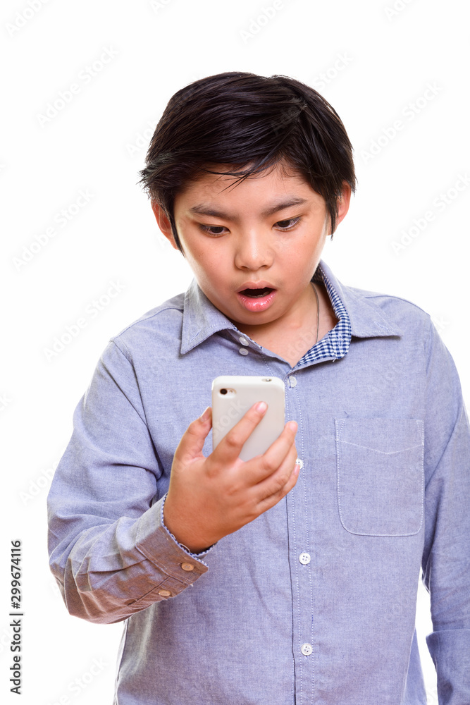Studio shot of Japanese boy isolated against white background Studio shot of Japanese boy isolated against white background