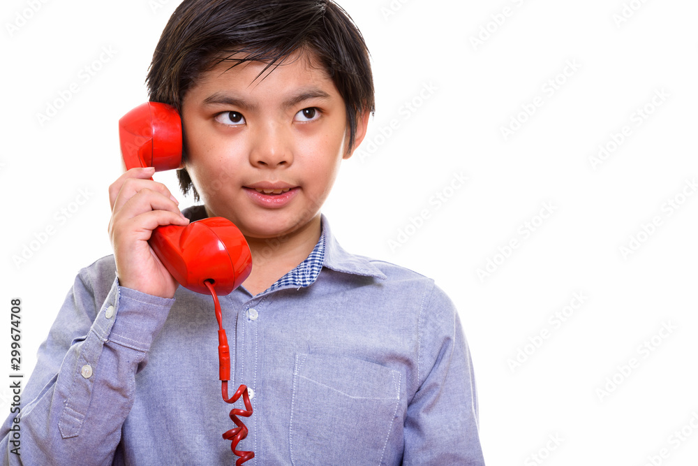 Studio shot of Japanese boy isolated against white background Studio shot of Japanese boy isolated against white background